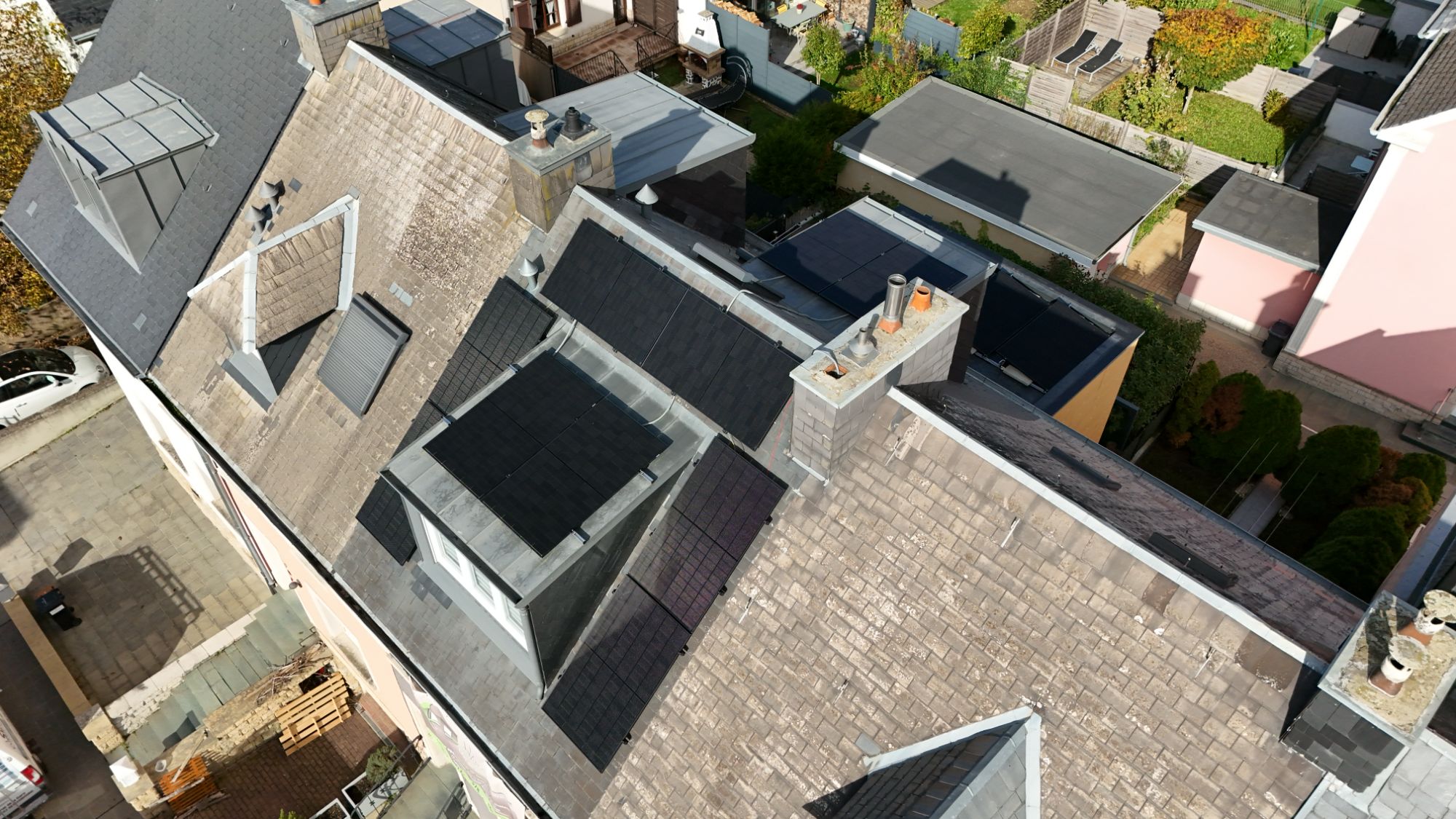 Vue drone de toitures équipées de panneaux solaires dans un quartier résidentiel — Céleste Énergie